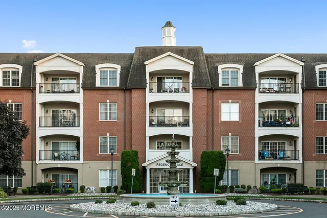 a front view of a building with a yard