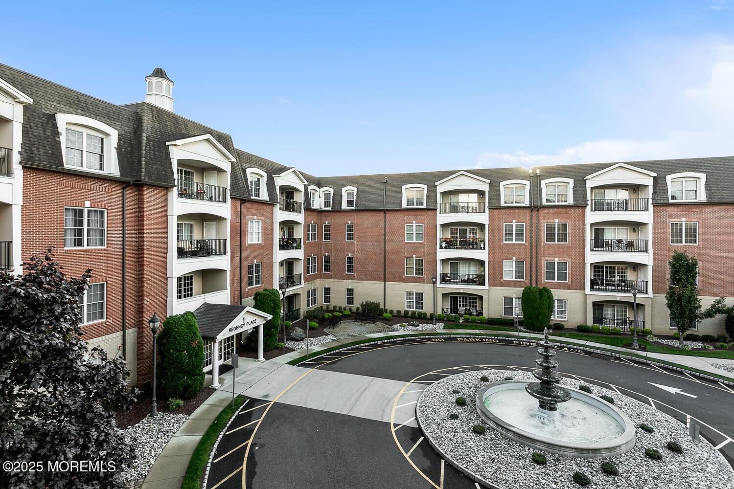 325 Regency Place Woodbridge, NJ 07095 - Photo 36 of 37 a front view of a building with street view and a fountain