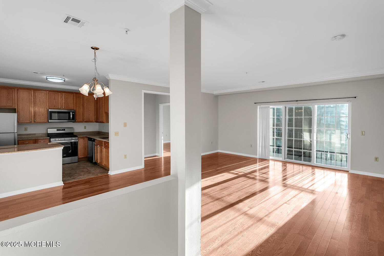 325 Regency Place Woodbridge, NJ 07095 - Photo 7 of 37 a open kitchen with granite countertop a stove top oven a sink dishwasher a dining table and chairs with wooden floor