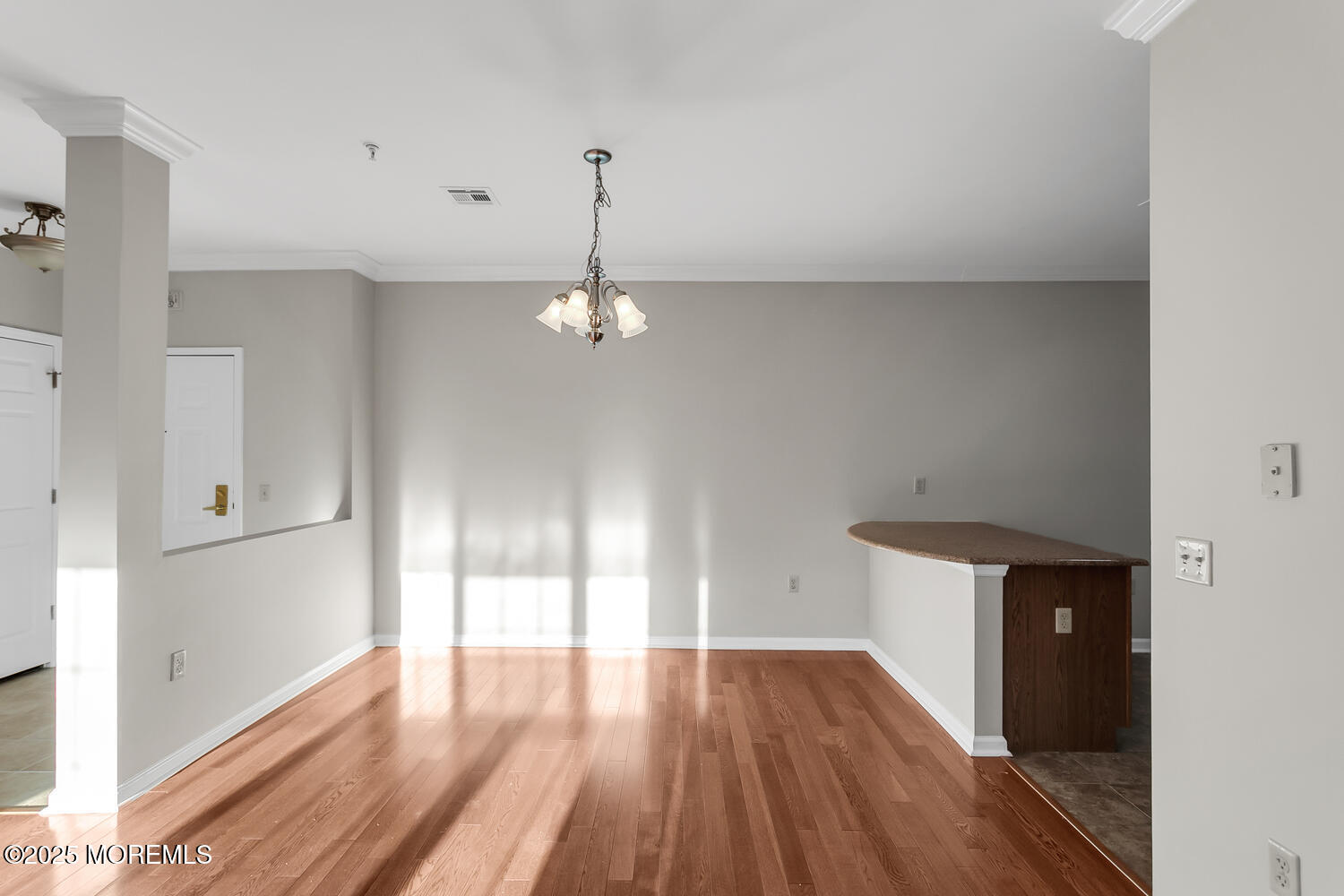 325 Regency Place Woodbridge, NJ 07095 - Photo 8 of 37 a view of empty room with wooden floor and fan