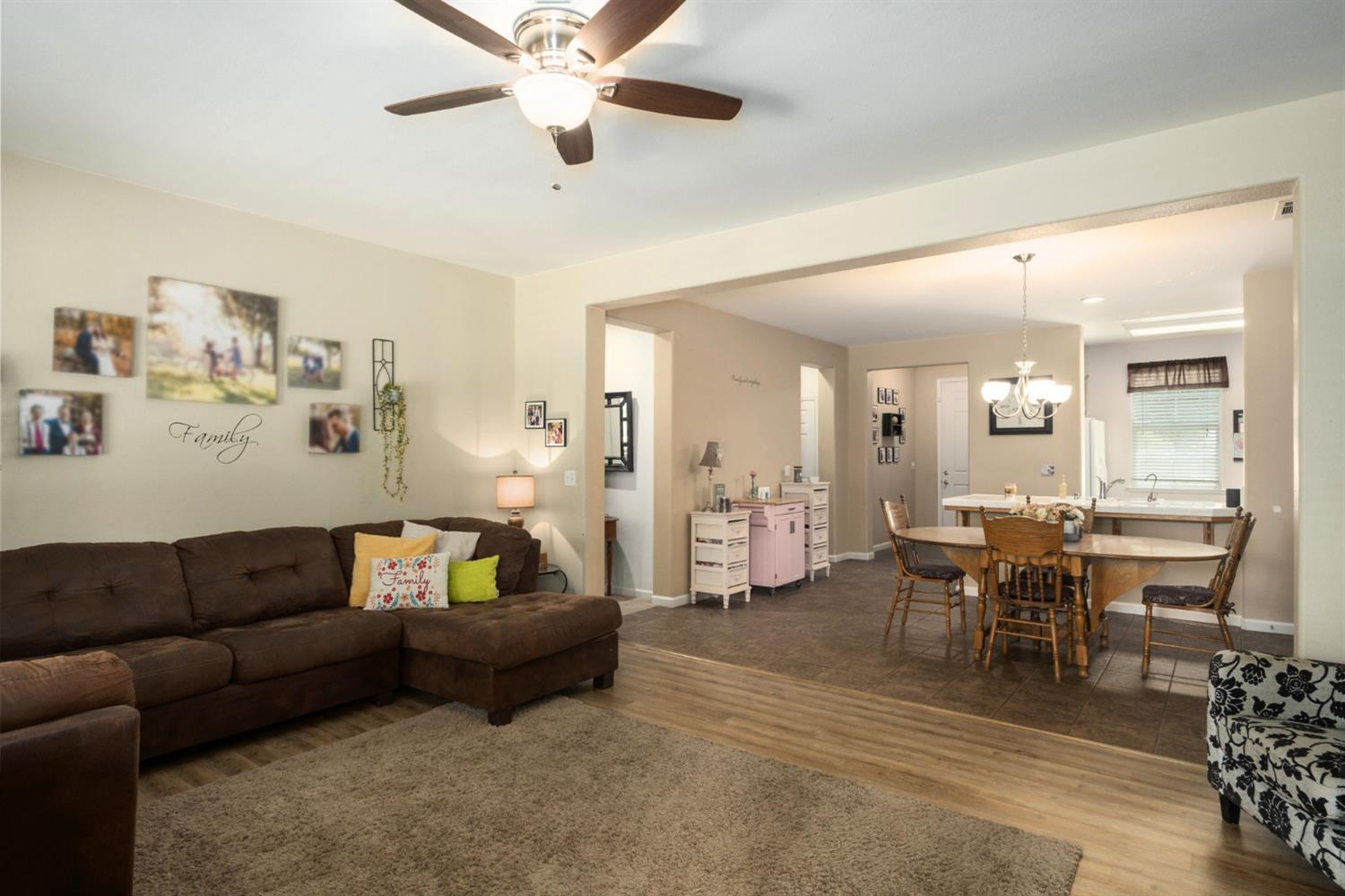 454 Sierra Avenue Reedley, CA 93654 - Photo 11 of 25 a living room with furniture and a dining table with wooden floor