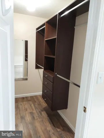 a view of walk in closet with empty racks