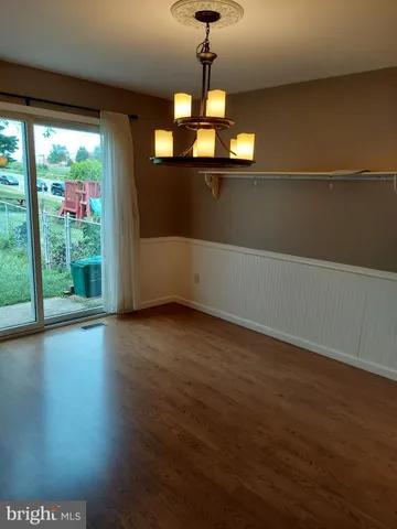 a view of a room with wooden floor and windows