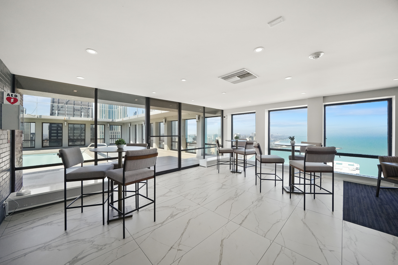 260 East Chestnut Street, Unit 406 Chicago, IL 60611 - Photo 18 of 25 a outdoor space with lots of tables a large window and chairs