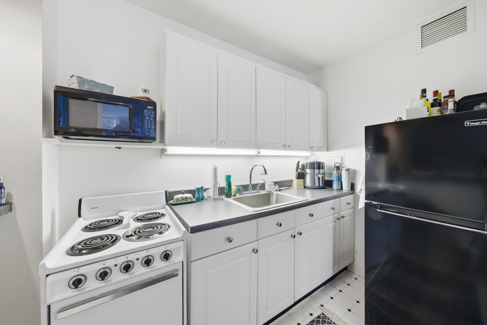 260 East Chestnut Street, Unit 406 Chicago, IL 60611 - Photo 7 of 25 a kitchen with stainless steel appliances a stove a sink and a refrigerator