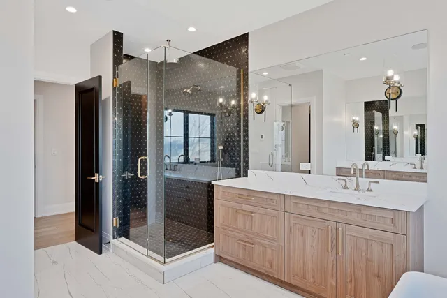 a bathroom with a double vanity sink mirror and shower