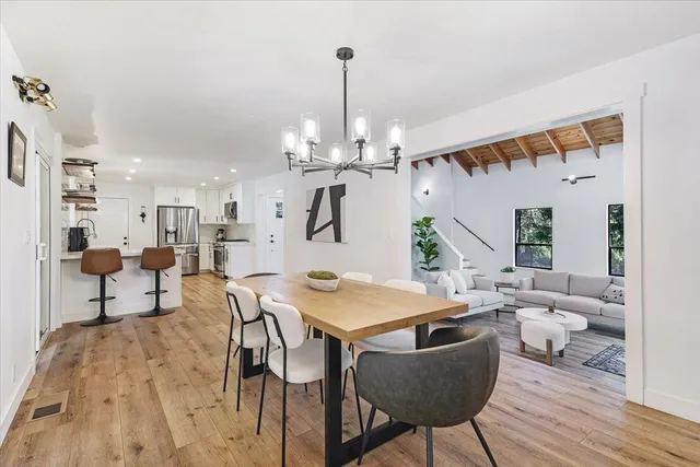 a view of a dining room with furniture and wooden floor