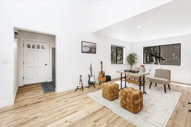 a living room with furniture a flat screen tv and a table