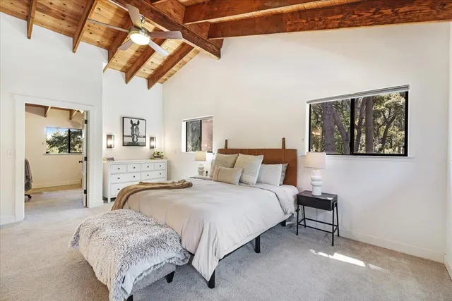 a spacious bedroom with a bed and a couch