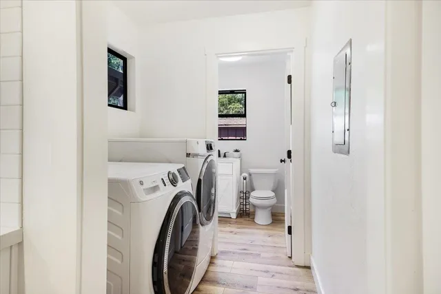a bathroom with a toilet a sink and a window