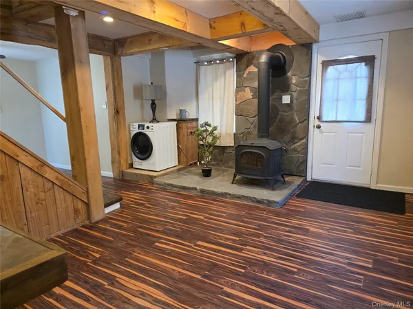 a view of entryway and hall with wooden floor