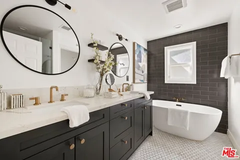 a bathroom with a double vanity sink and a mirror