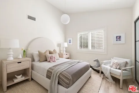 a bedroom with a bed and a couch