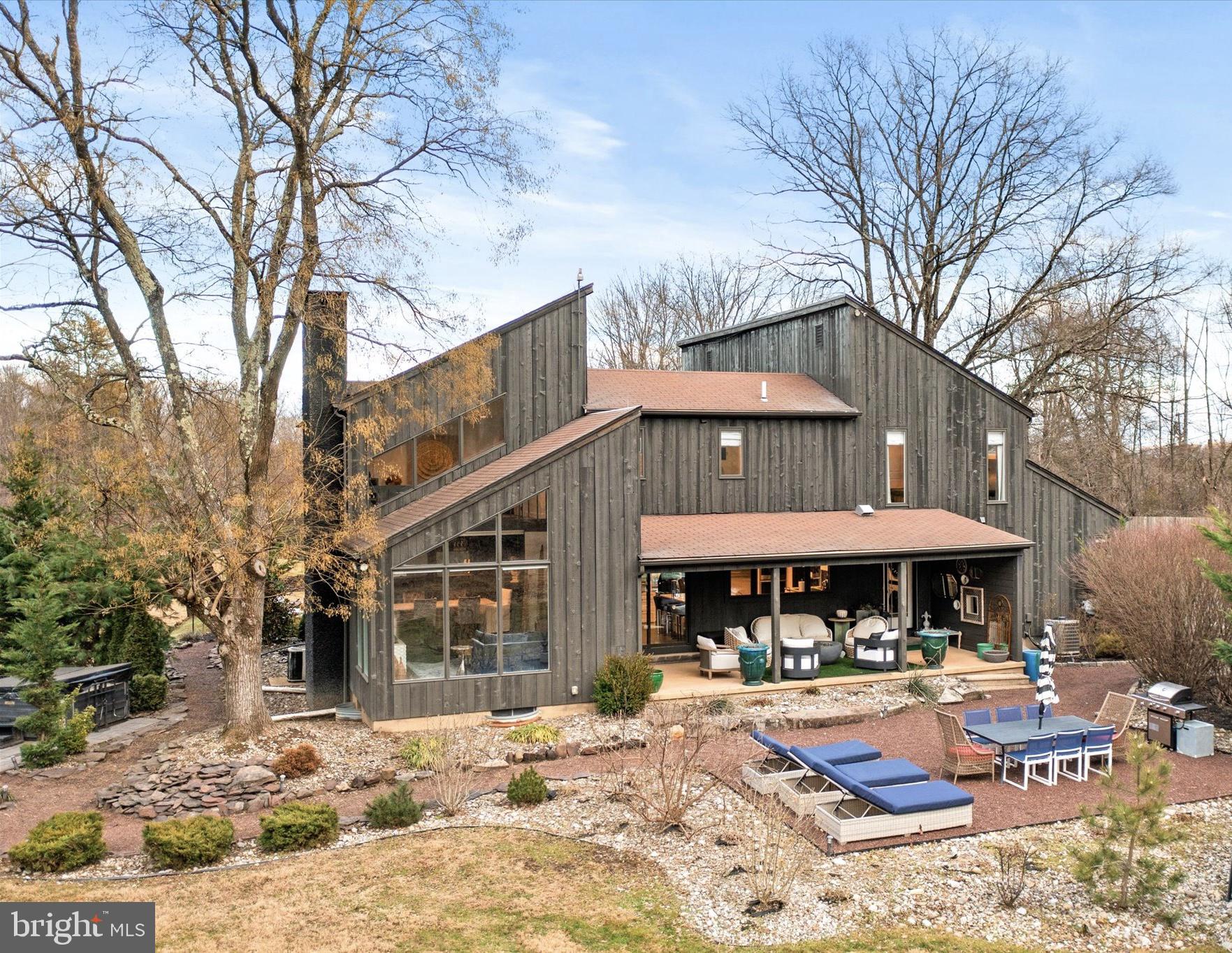 a front view of a house with yard patio and outdoor seating
