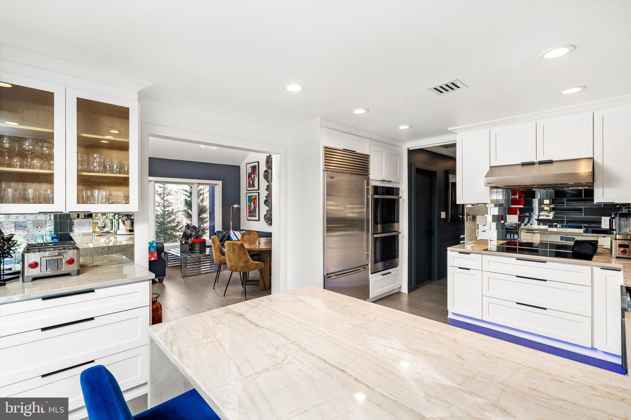 1615 Harbourton Rocktown Road Lambertville, NJ 08530 - Photo 11 of 50 a kitchen with stainless steel appliances kitchen island granite countertop a refrigerator oven stove a dining table and chairs with wooden floor