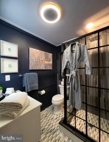 a bedroom with a bed a television and a large window