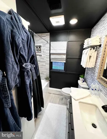 a bedroom with a bed and a mirror