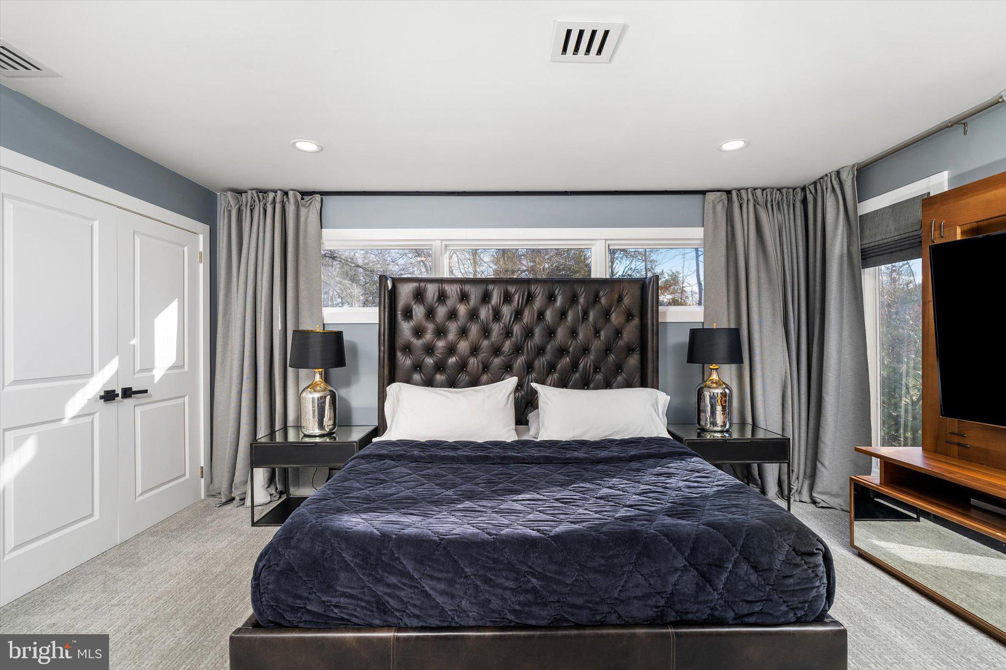 1615 Harbourton Rocktown Road Lambertville, NJ 08530 - Photo 24 of 50 a bedroom with a large bed and a flat tv screen