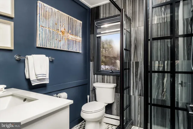 a white toilet sitting next to a bathroom sink