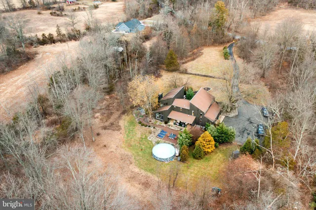 a view of a house with a table and chairs in patio