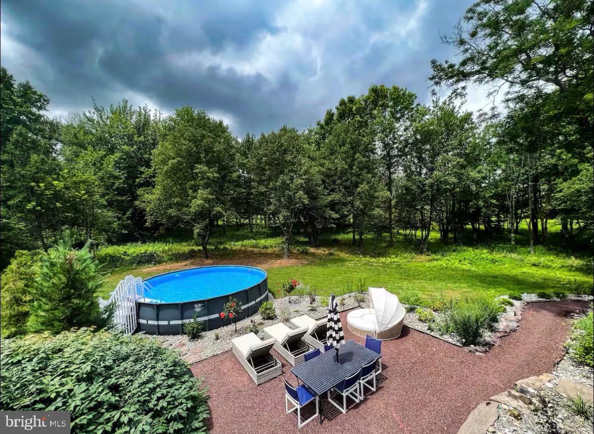 1615 Harbourton Rocktown Road Lambertville, NJ 08530 - Photo 47 of 50 a view of a swimming pool with lawn chairs under an umbrella