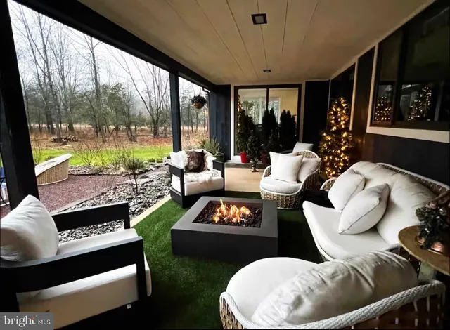 a living room with furniture and a floor to ceiling window