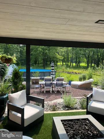 a view of entryway bedroom and hall with wooden floor