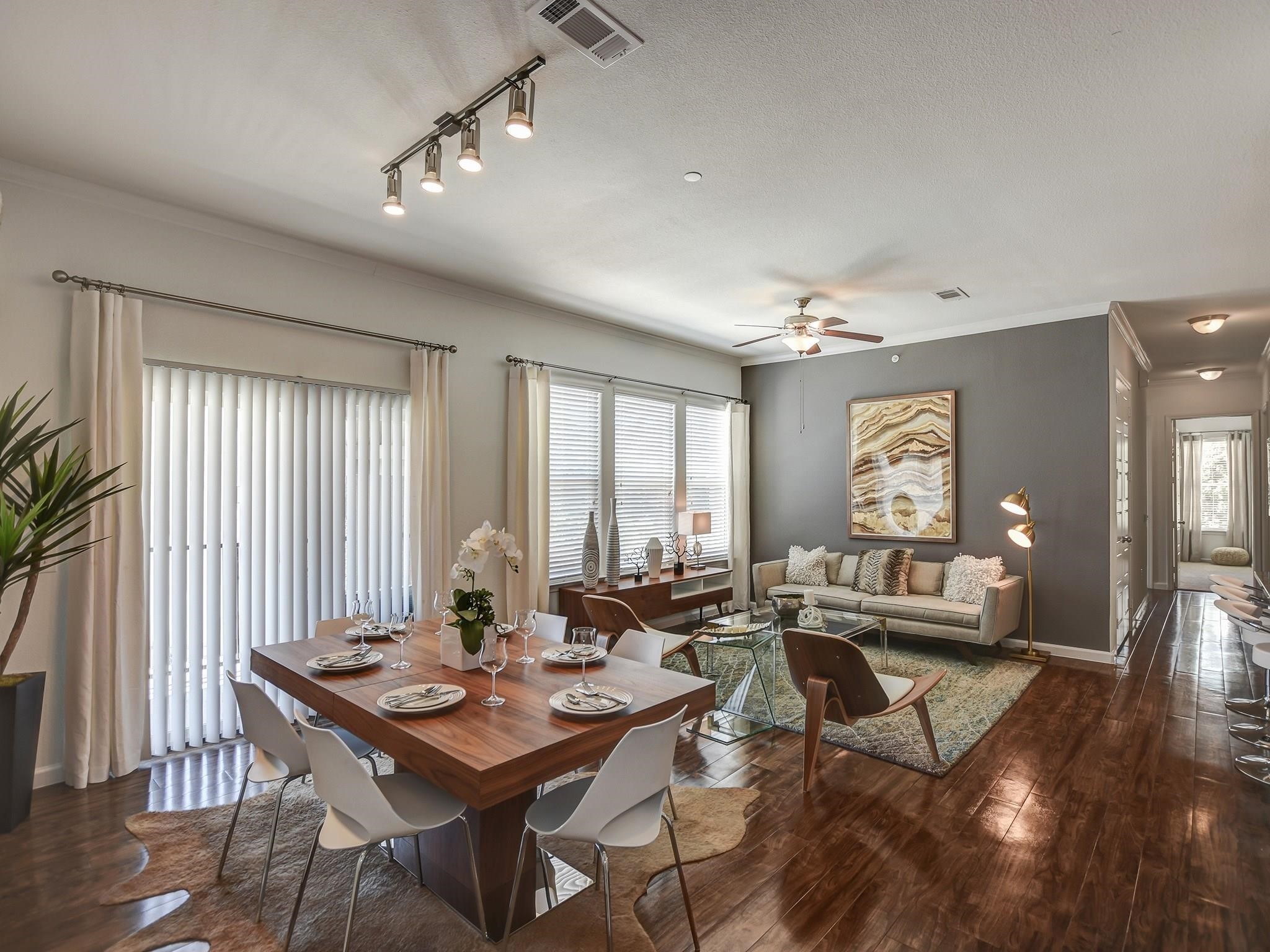 a view of a a dining room with furniture window and wooden floor