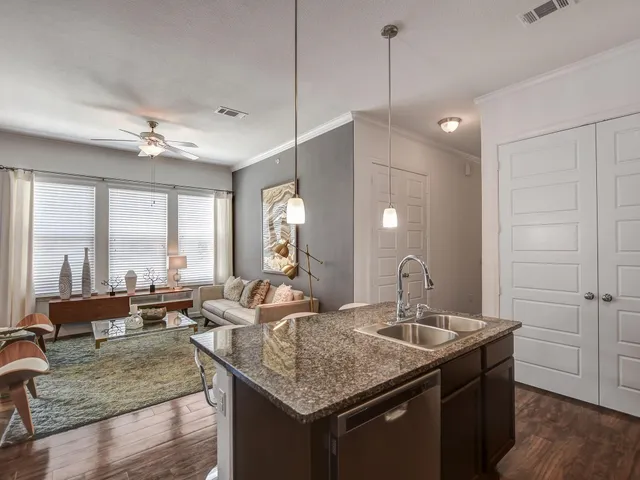 a kitchen with sink refrigerator and large window
