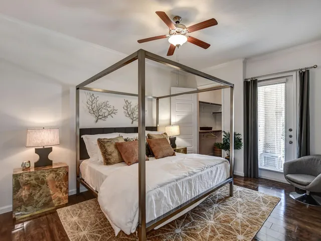 a bedroom with a large bed and a chandelier