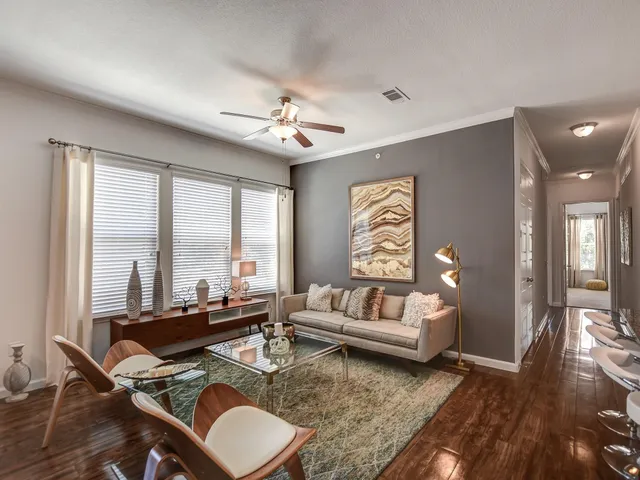 a living room with furniture and wooden floor