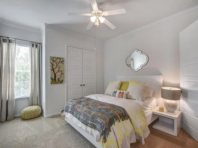 a bedroom with a bed and a window