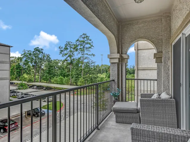 a balcony view with couple of chairs