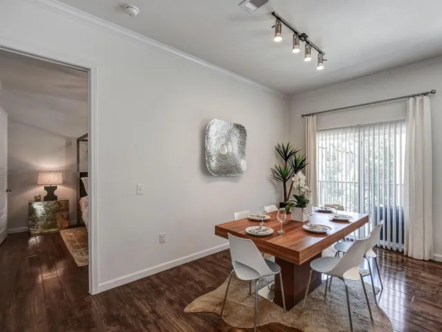 a view of a dining room with furniture and wooden floor