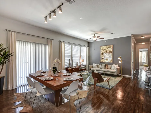 a view of a a dining room with furniture window and wooden floor