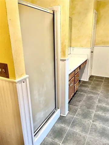 a bathroom with a mirror and a shower