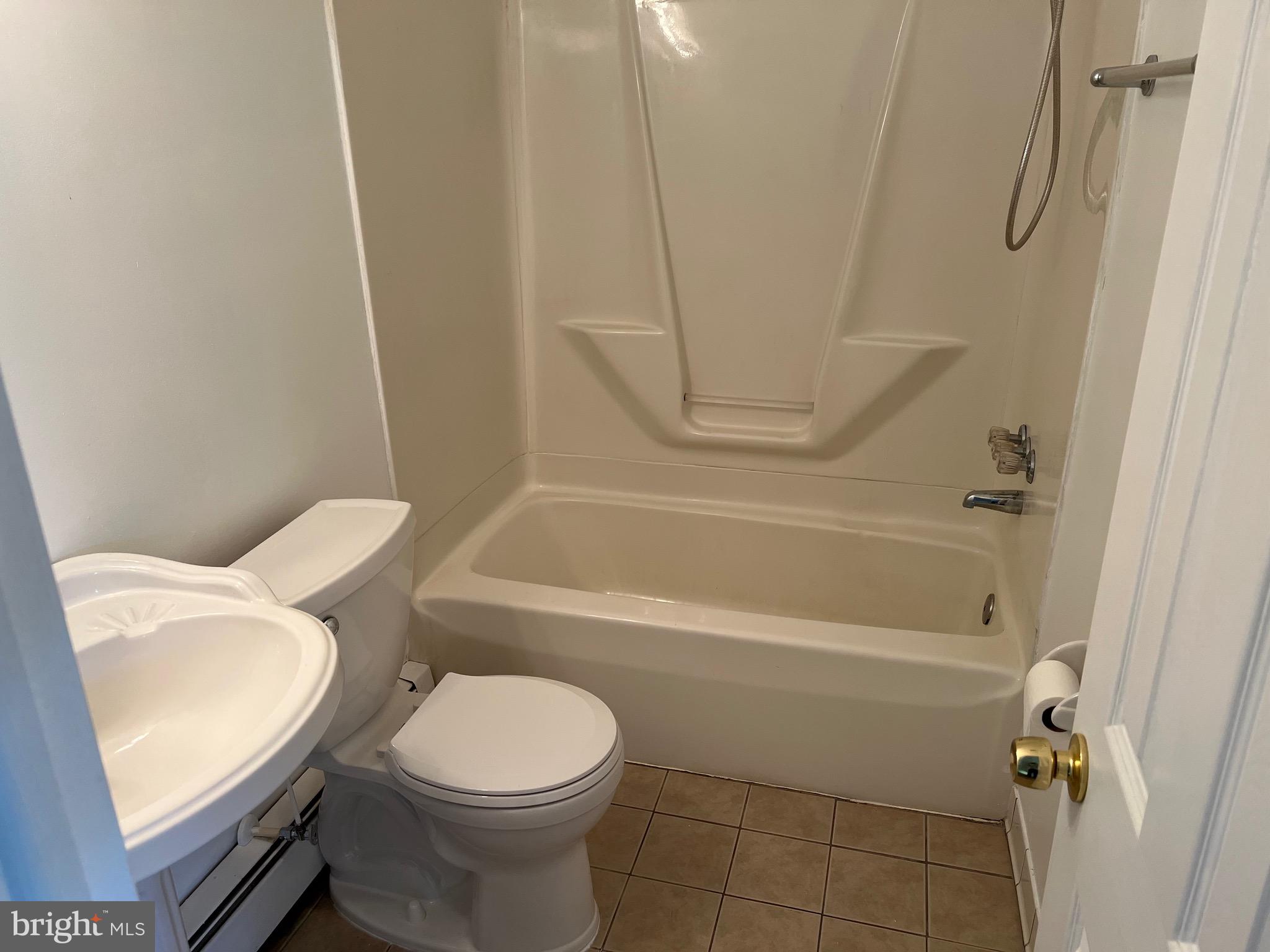 4729 Conowingo Road Darlington, MD 21034 - Photo 11 of 26 a white toilet sitting next to a bath tub