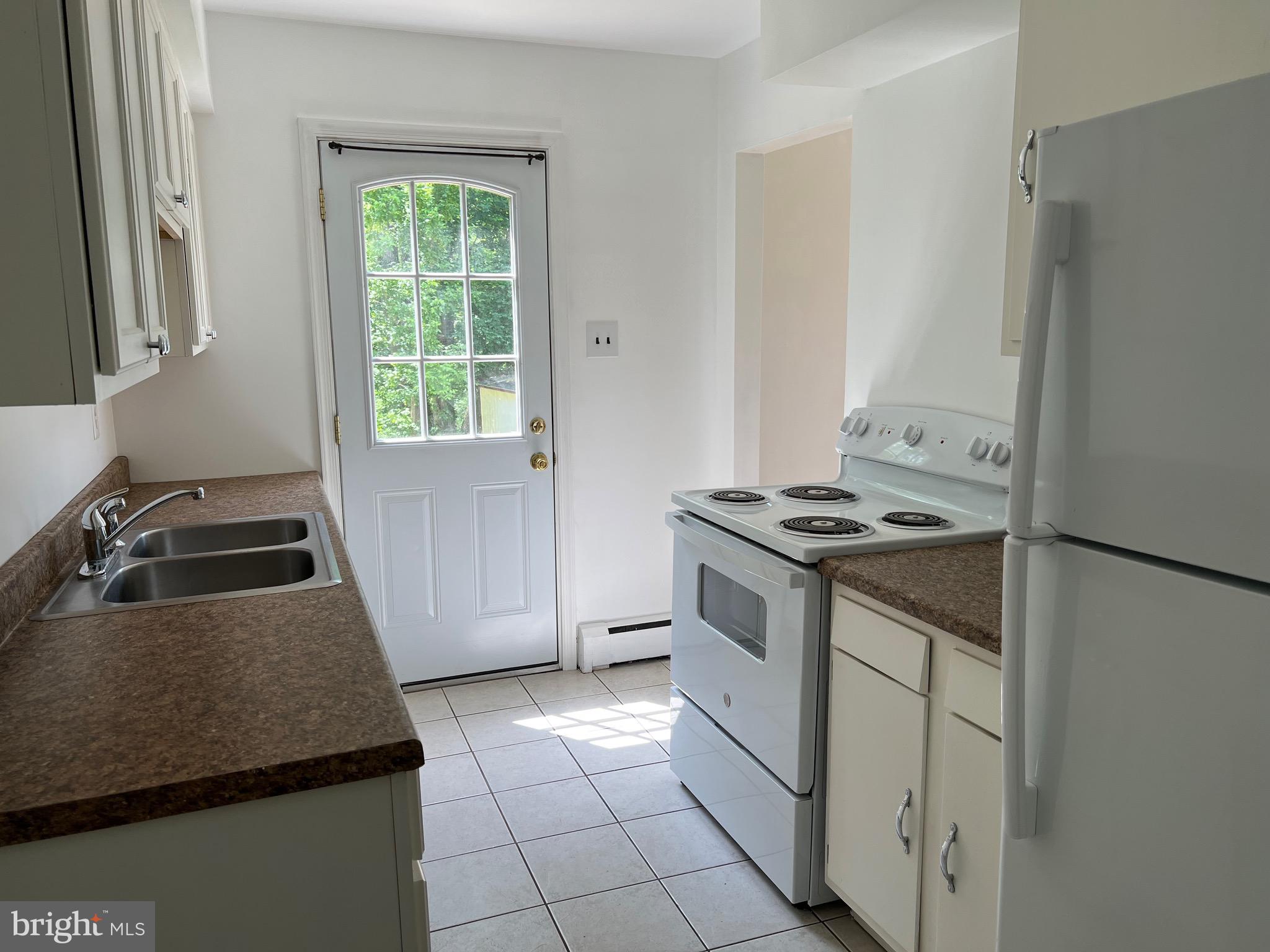 4729 Conowingo Road Darlington, MD 21034 - Photo 12 of 26 a kitchen with granite countertop a sink stove and refrigerator