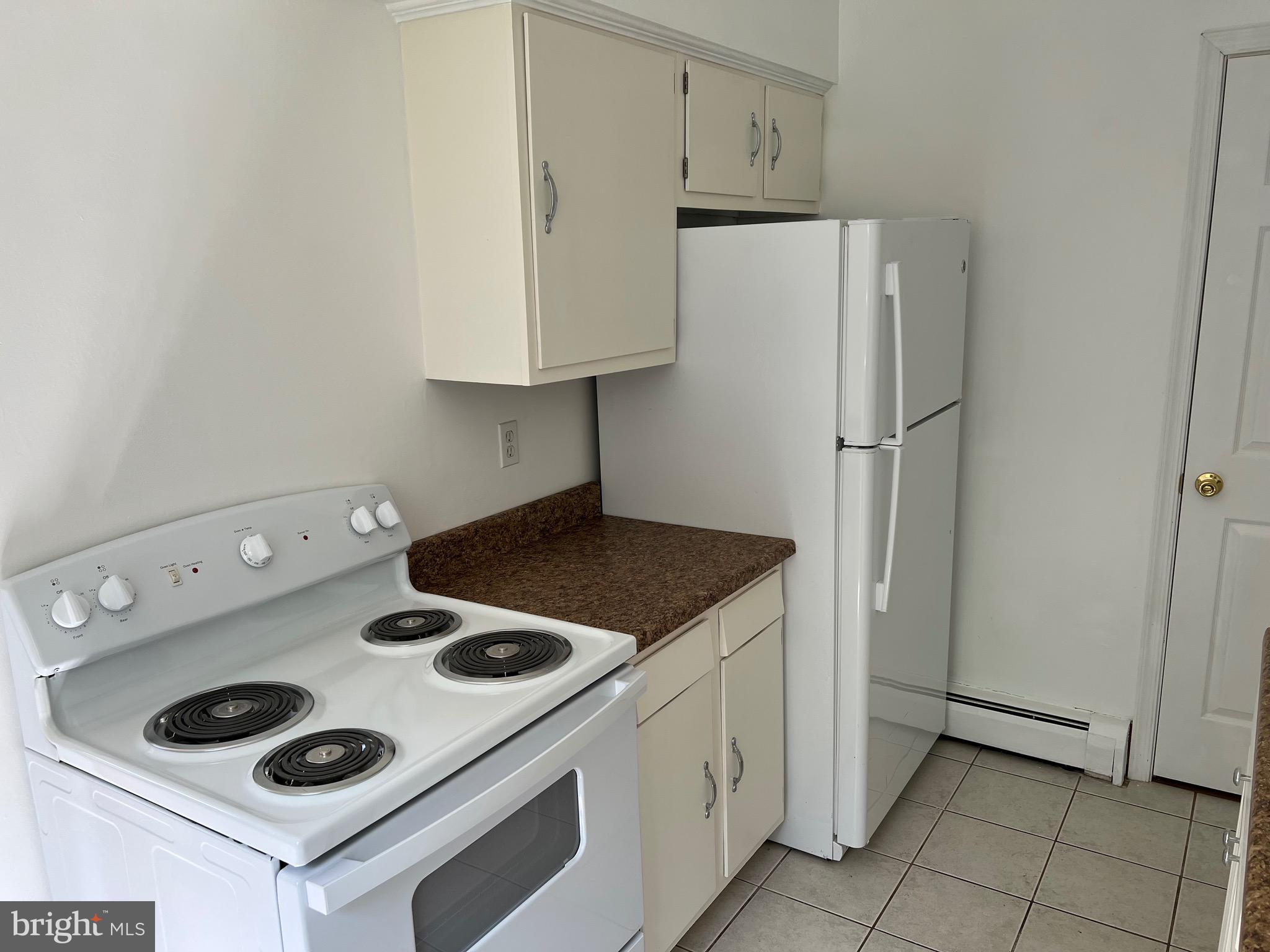 4729 Conowingo Road Darlington, MD 21034 - Photo 13 of 26 a kitchen with a stove and a refrigerator