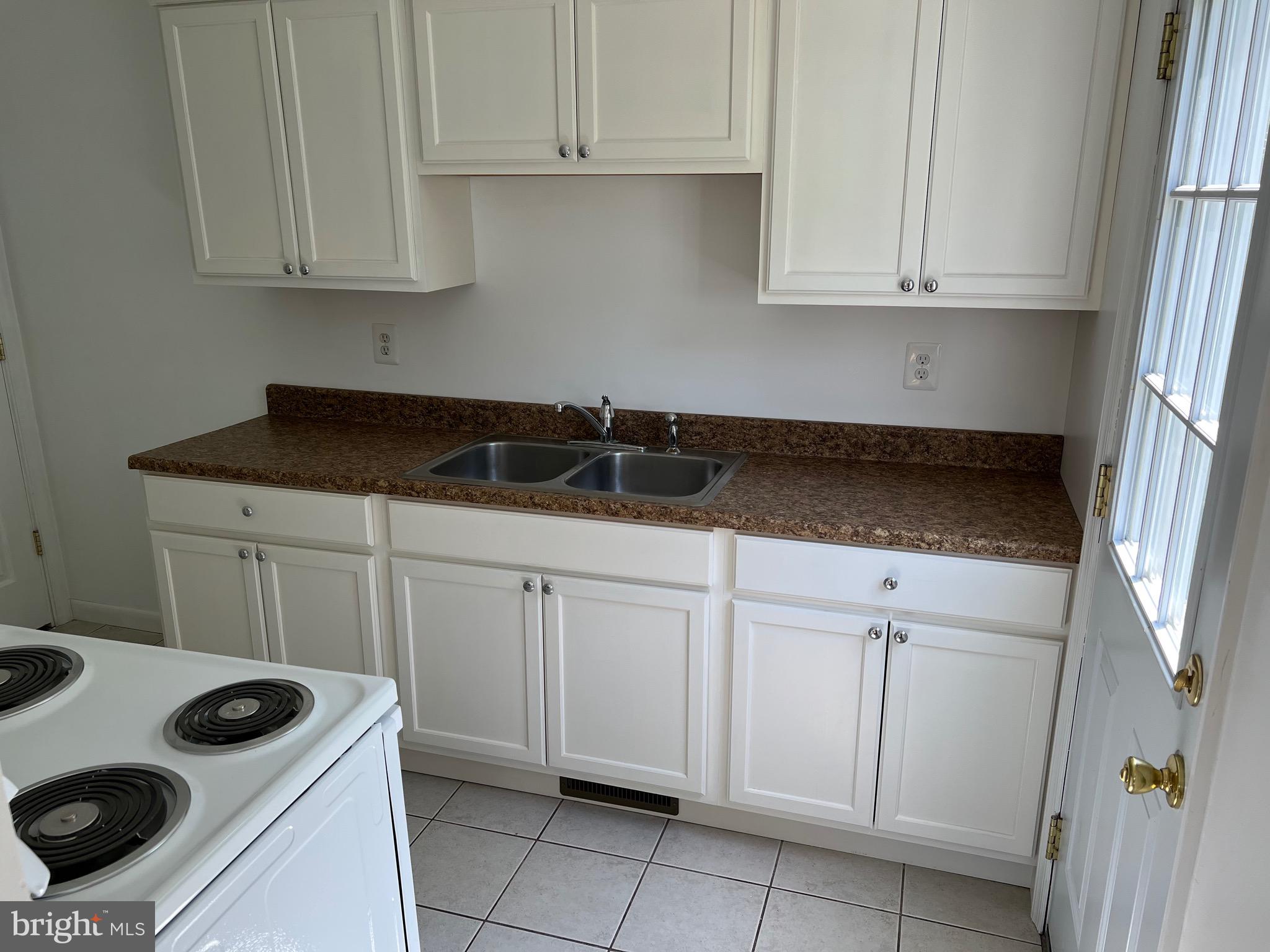4729 Conowingo Road Darlington, MD 21034 - Photo 17 of 26 a kitchen with white cabinets and white appliances