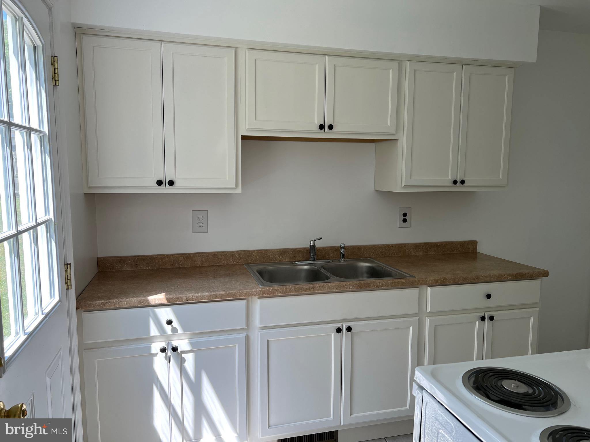 4729 Conowingo Road Darlington, MD 21034 - Photo 18 of 26 a kitchen with granite countertop a sink a stove and cabinets