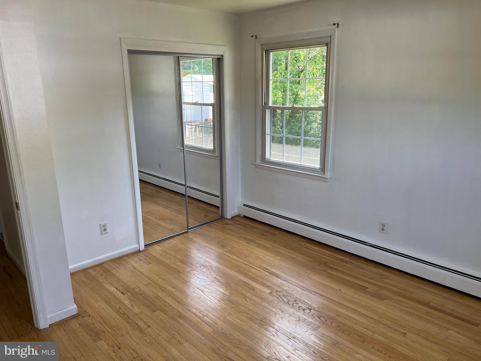 4729 Conowingo Road Darlington, MD 21034 - Photo 6 of 26 an empty room with wooden floor and windows