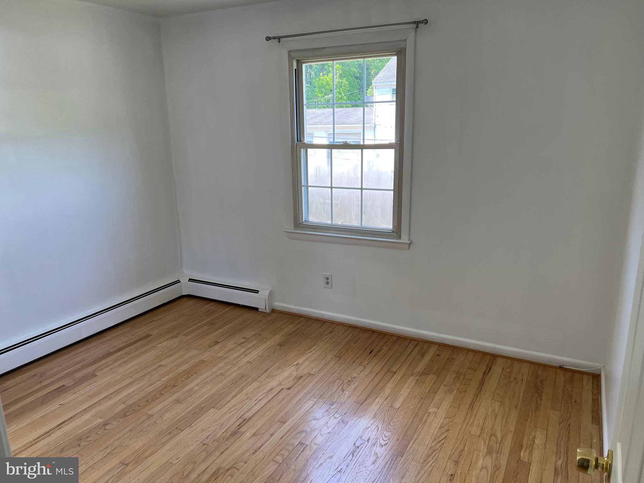 4729 Conowingo Road Darlington, MD 21034 - Photo 7 of 26 an empty room with wooden floor and windows