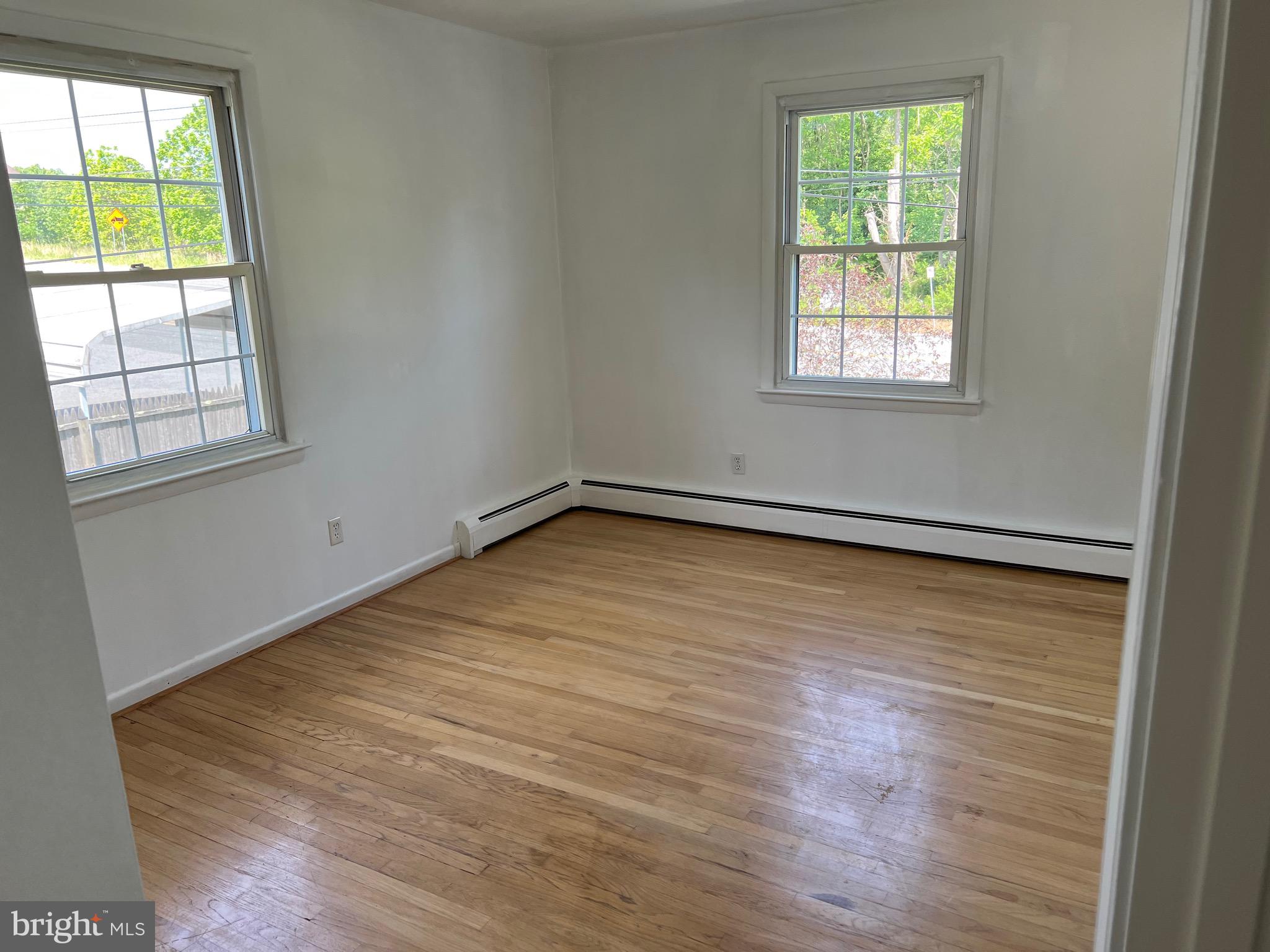 4729 Conowingo Road Darlington, MD 21034 - Photo 8 of 26 an empty room with wooden floor and windows