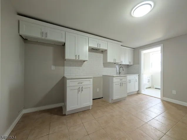 a kitchen with white cabinets