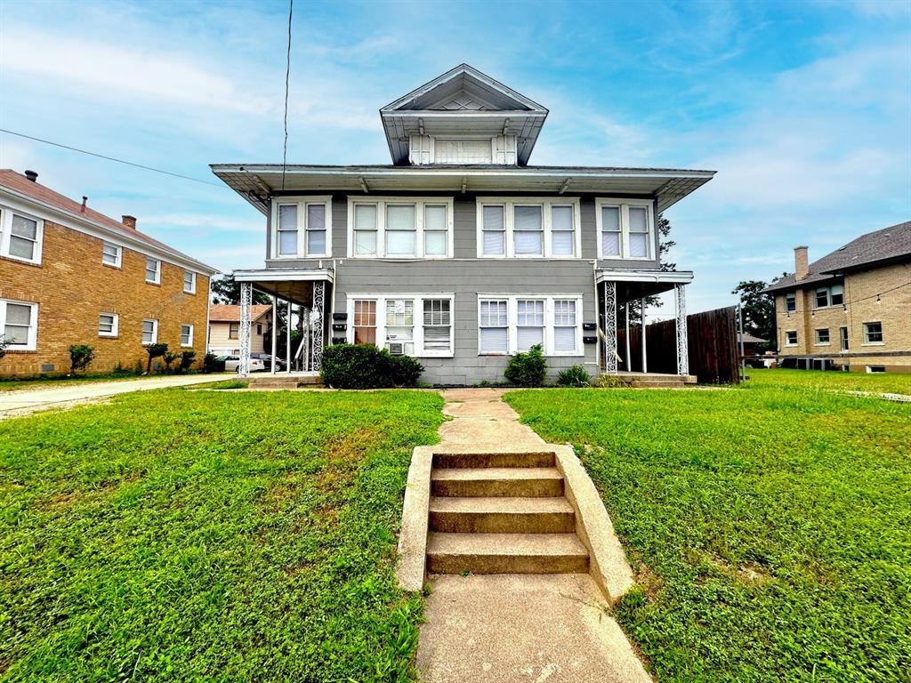 a front view of a house with a yard table and chairs