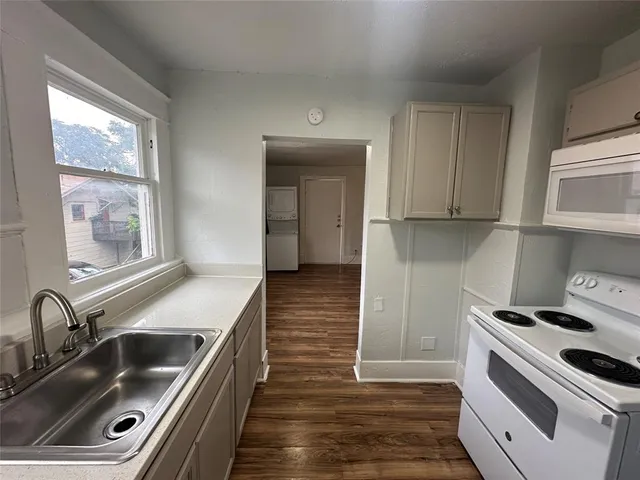 a kitchen that has a sink and a stove