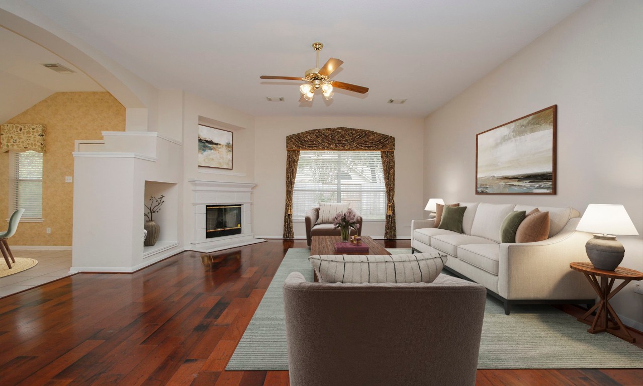 1114 Bringewood Chase Drive Spring, TX 77379 - Photo 13 of 49 a living room with furniture a fireplace and a chandelier