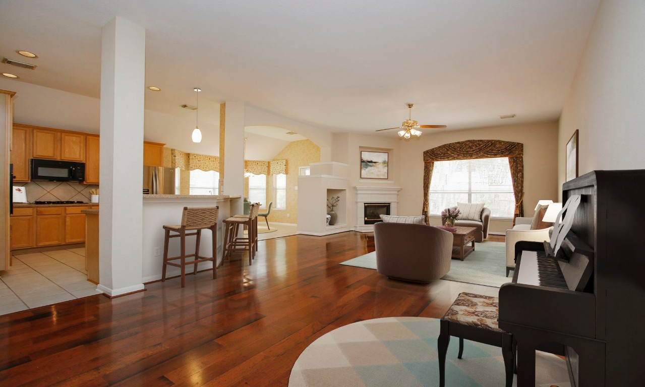 1114 Bringewood Chase Drive Spring, TX 77379 - Photo 15 of 49 a living room with furniture wooden floor and a large window