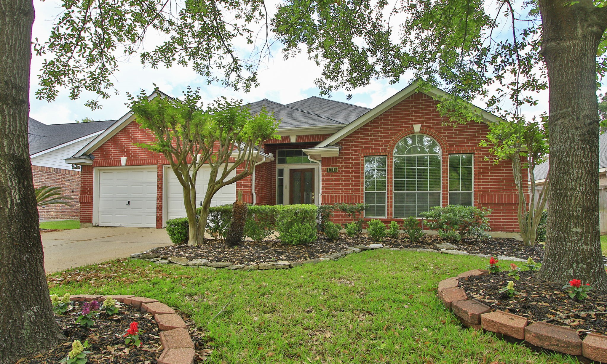 1114 Bringewood Chase Drive Spring, TX 77379 - Photo 2 of 44 Well maintained landscaping with mature trees